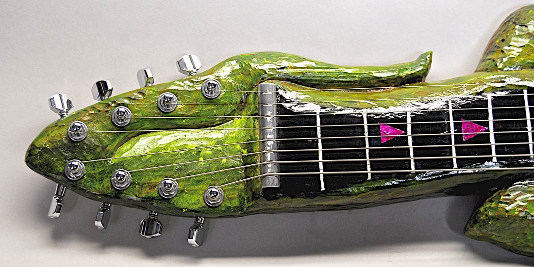 button - photo of hand carved alligator lap steel
